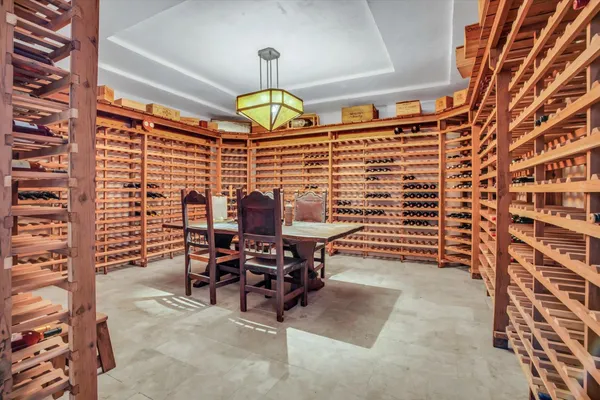a view of a dining room with furniture and chandelier
