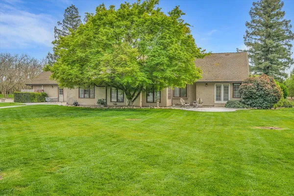 a view of house with backyard