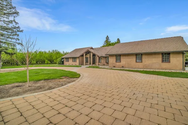 a house with green field in front of it