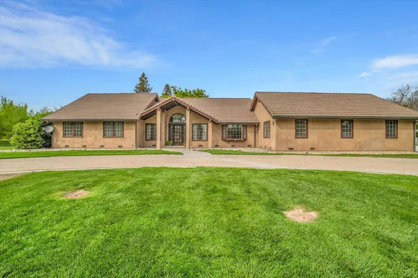 a front view of a house with a yard