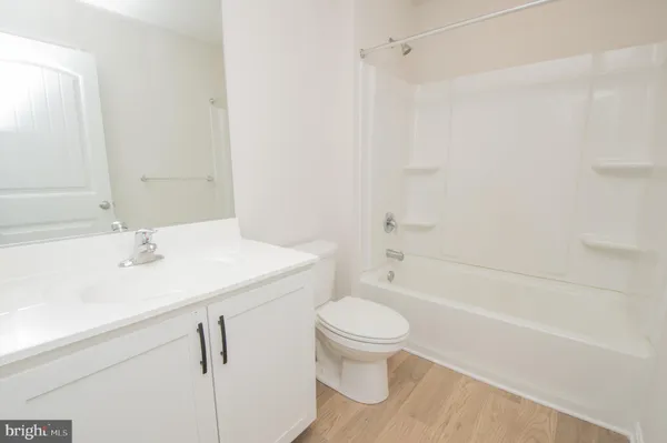 a bathroom with a sink a toilet and a bathtub