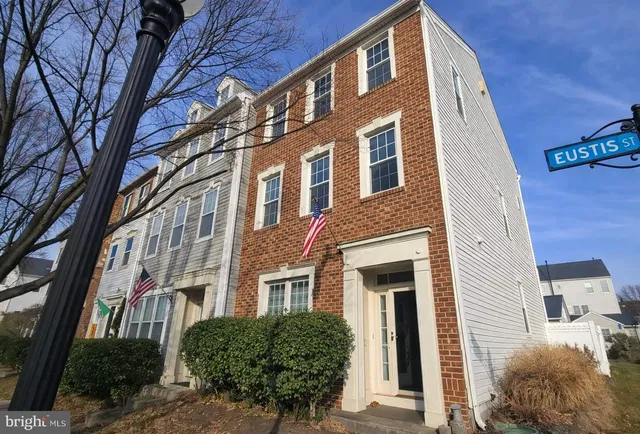 a view of a brick building next to a yard