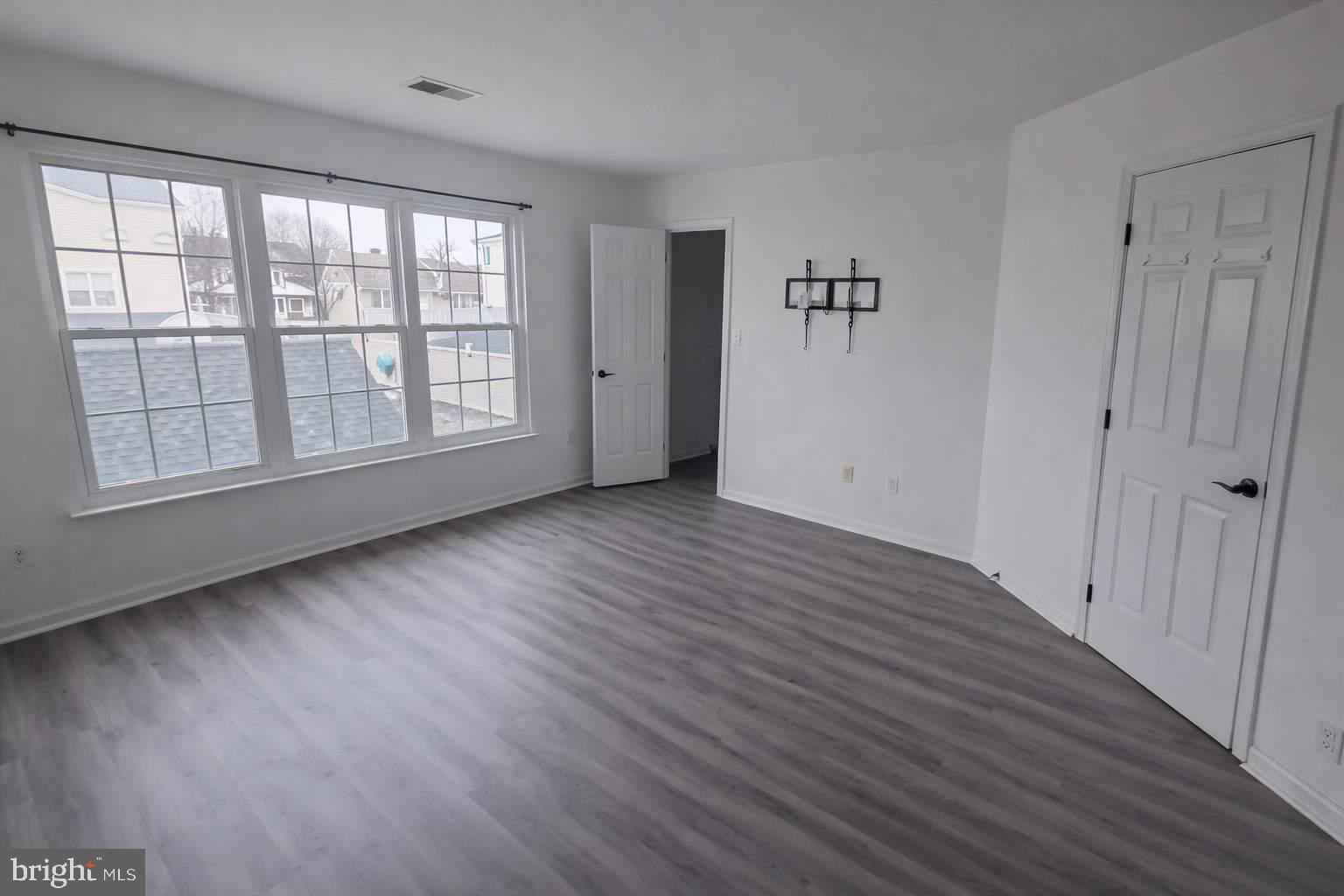 43068 Eustis Street Chantilly, VA 20152 - Photo 11 of 25 wooden floor in an empty room with a window
