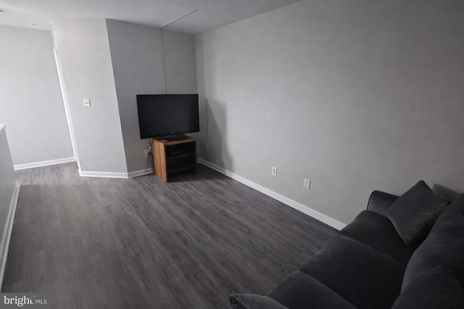 43068 Eustis Street Chantilly, VA 20152 - Photo 16 of 25 a living room with furniture and a flat screen tv