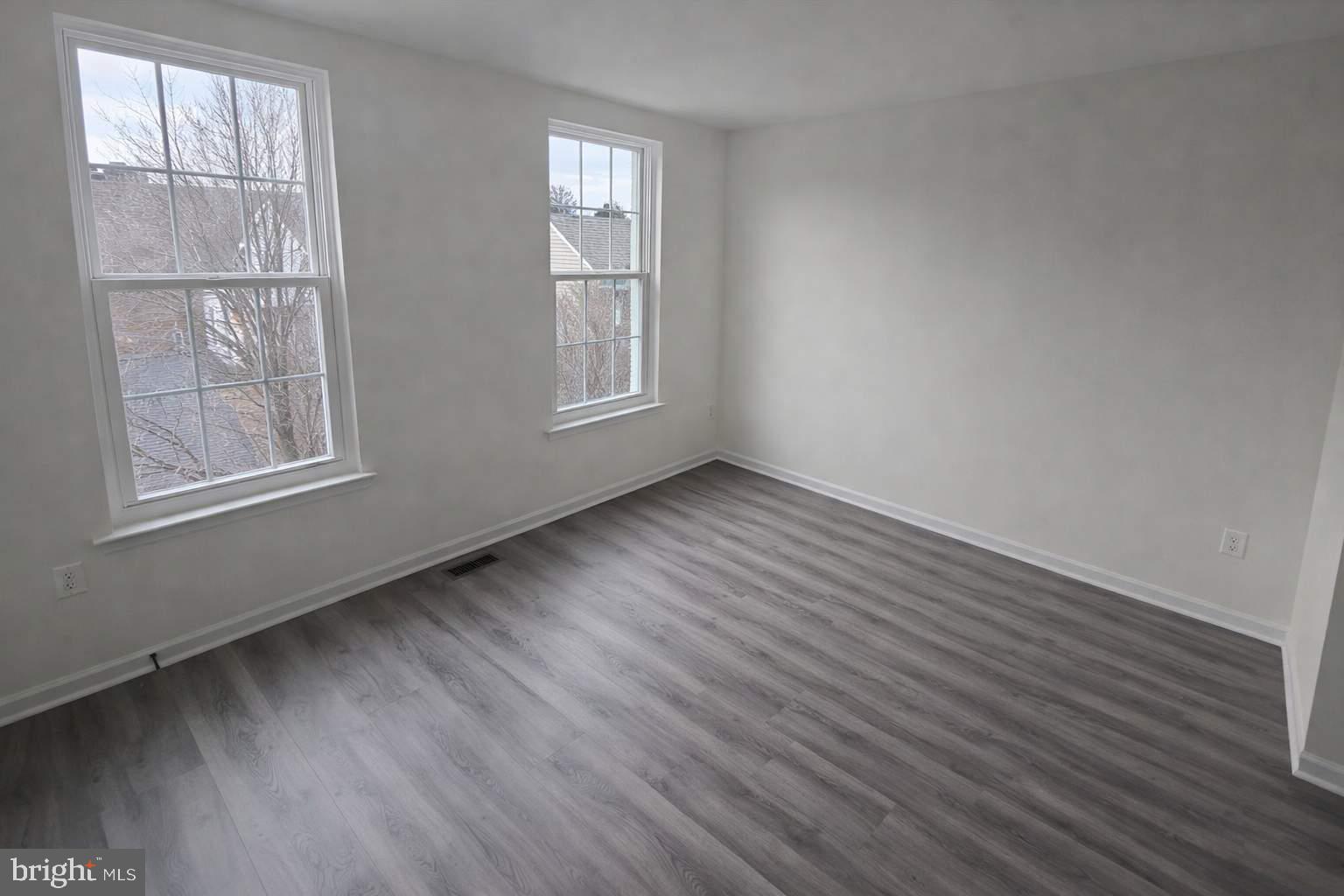 43068 Eustis Street Chantilly, VA 20152 - Photo 18 of 25 an empty room with wooden floor and windows