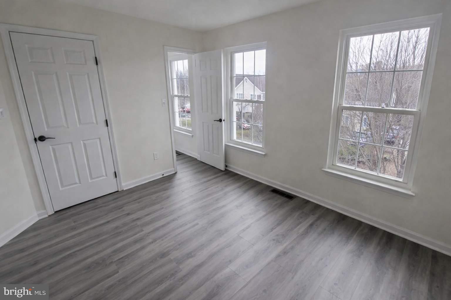 43068 Eustis Street Chantilly, VA 20152 - Photo 19 of 25 a view of an empty room with wooden floor and a window
