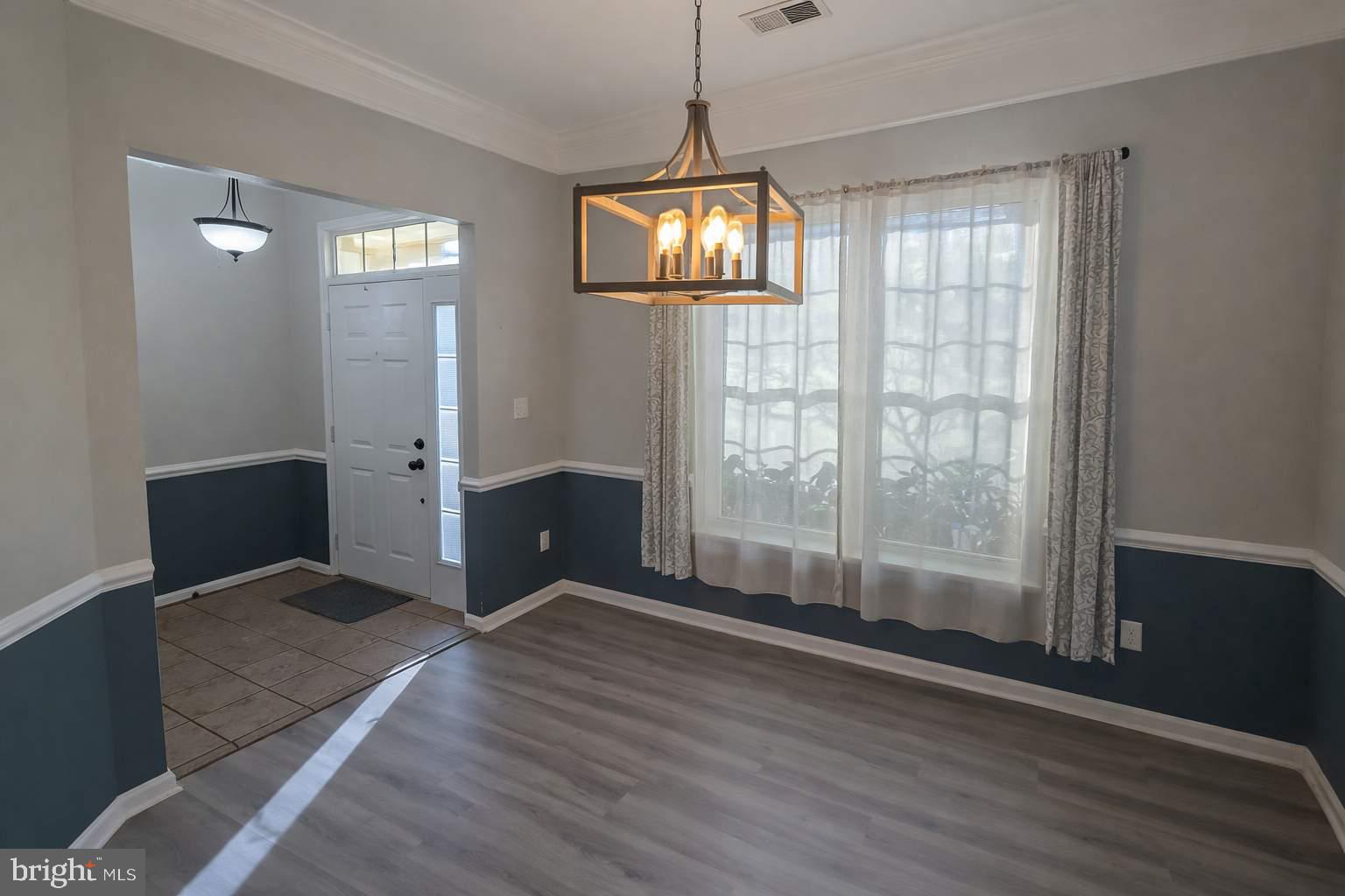43068 Eustis Street Chantilly, VA 20152 - Photo 2 of 25 an empty room with wooden floor and windows