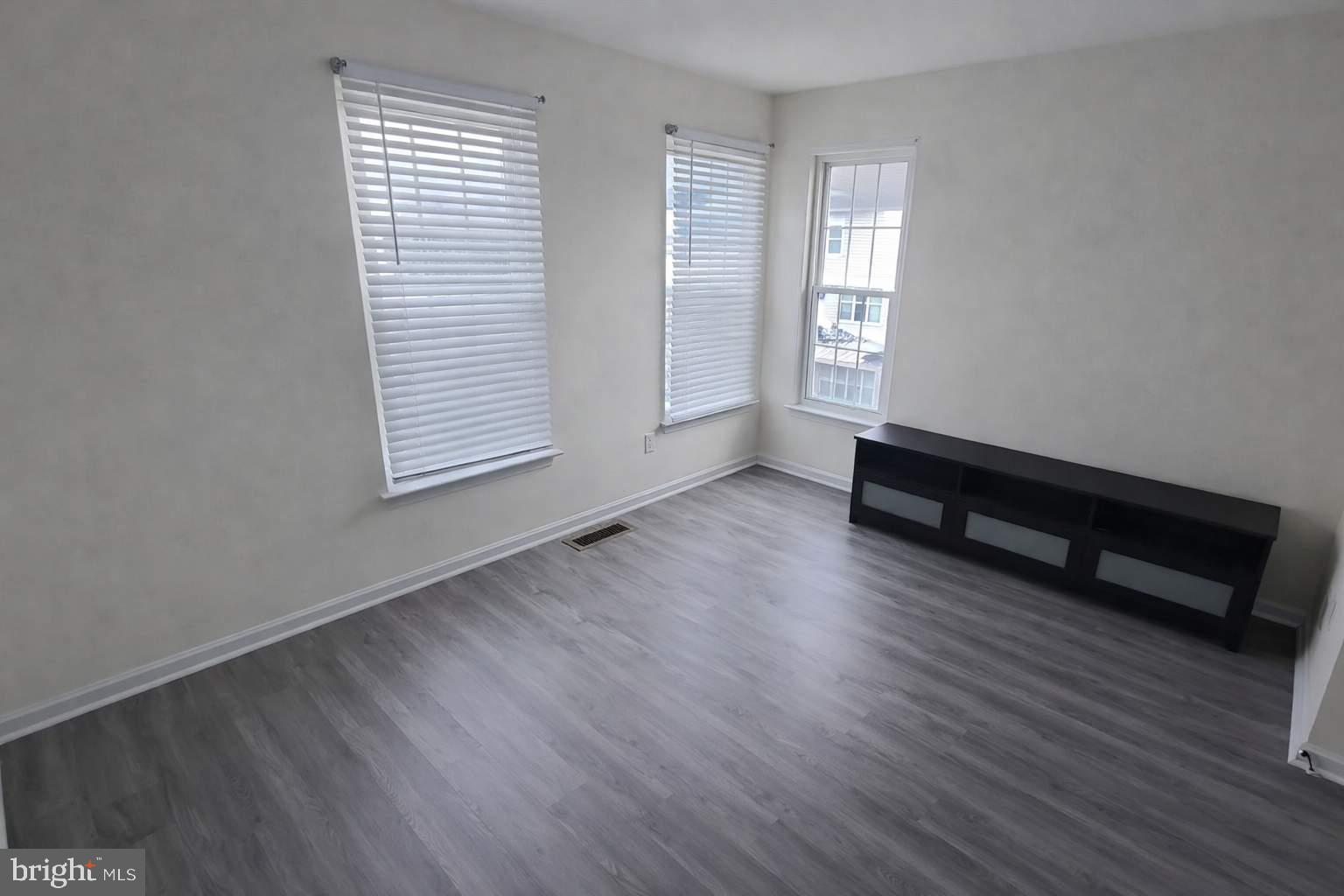 43068 Eustis Street Chantilly, VA 20152 - Photo 22 of 25 an empty room with wooden floor and windows