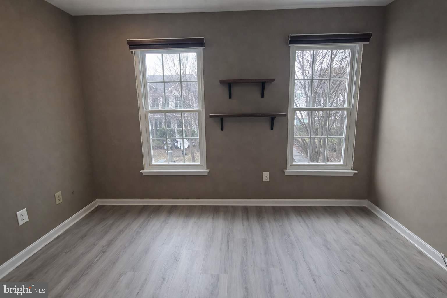 43068 Eustis Street Chantilly, VA 20152 - Photo 9 of 25 an empty room with wooden floor and windows