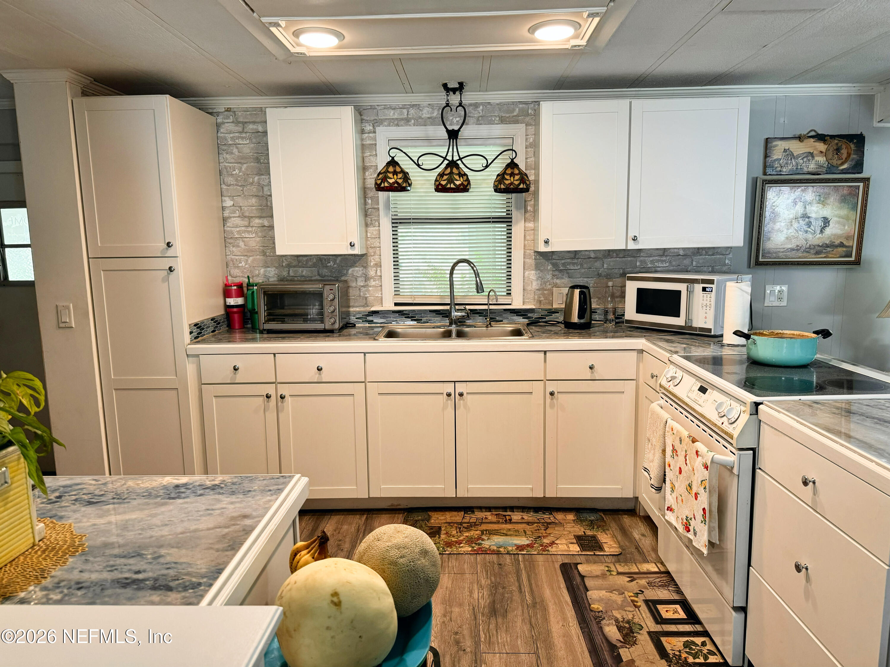 140 Keystone Road Palatka, FL 32177 - Photo 7 of 19 a kitchen with stainless steel appliances granite countertop a stove a sink and a refrigerator