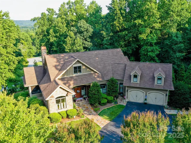 an aerial view of a house with garden space and a patio