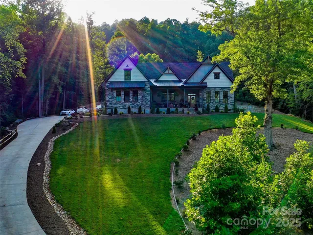 a view of a big house with a big yard and potted plants