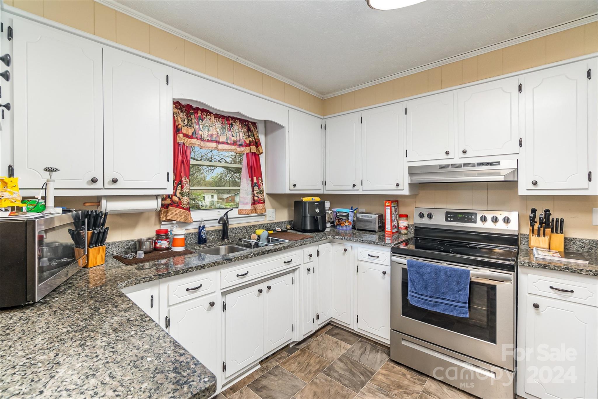 501 Weaver Street Cherryville, NC 28021 - Photo 11 of 26 a kitchen with stainless steel appliances granite countertop a stove a sink dishwasher and cabinets with wooden floor