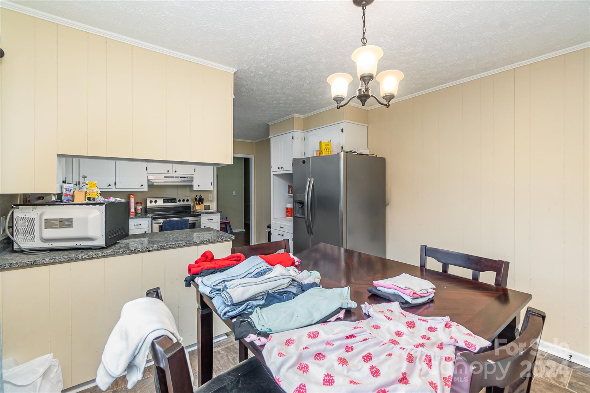 501 Weaver Street Cherryville, NC 28021 - Photo 13 of 26 a bedroom with a bed and a chandelier
