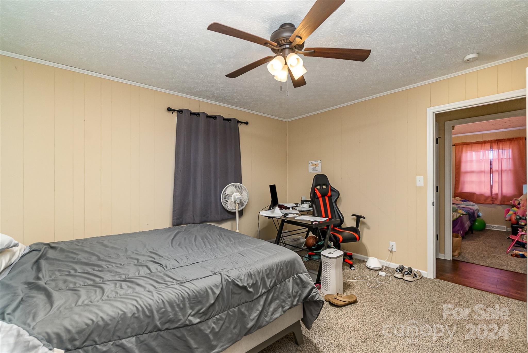 501 Weaver Street Cherryville, NC 28021 - Photo 15 of 26 a bed room with a bed and a chandelier