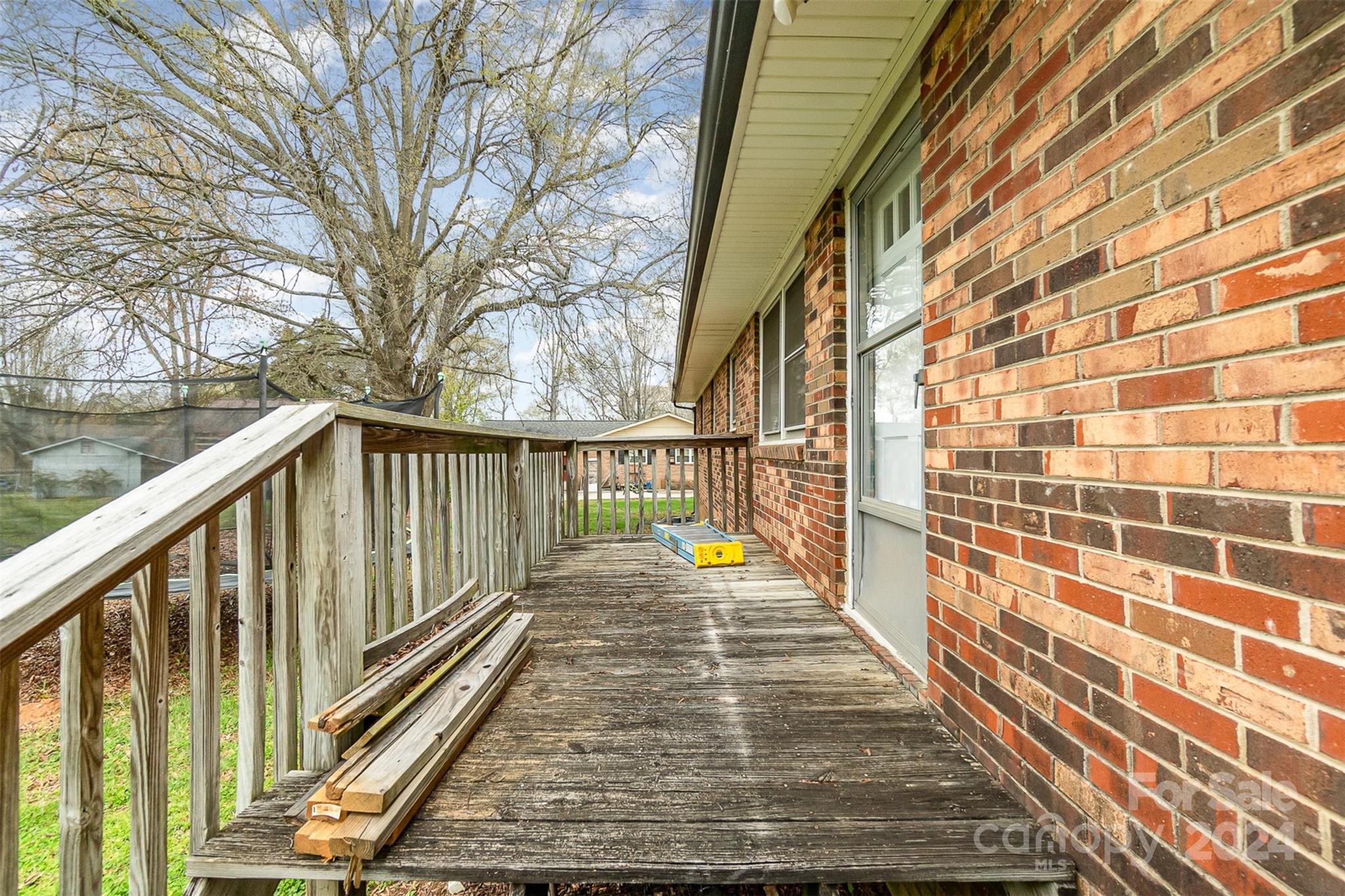501 Weaver Street Cherryville, NC 28021 - Photo 22 of 26 a view of a balcony with wooden floor and fence and a bench