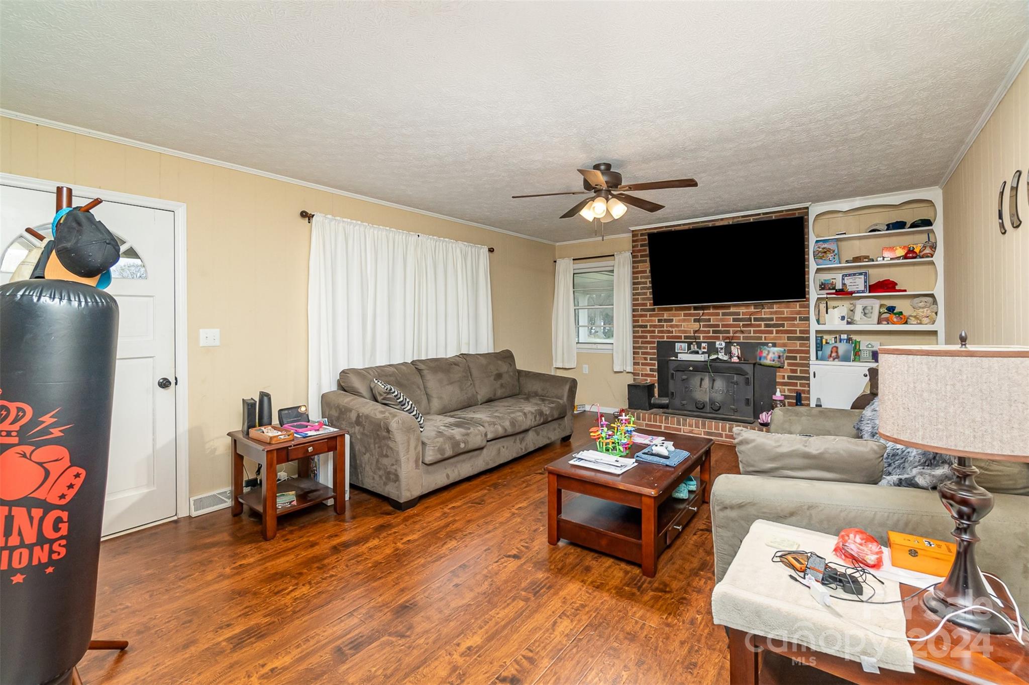 501 Weaver Street Cherryville, NC 28021 - Photo 6 of 26 a living room with furniture a flat screen tv and a fireplace