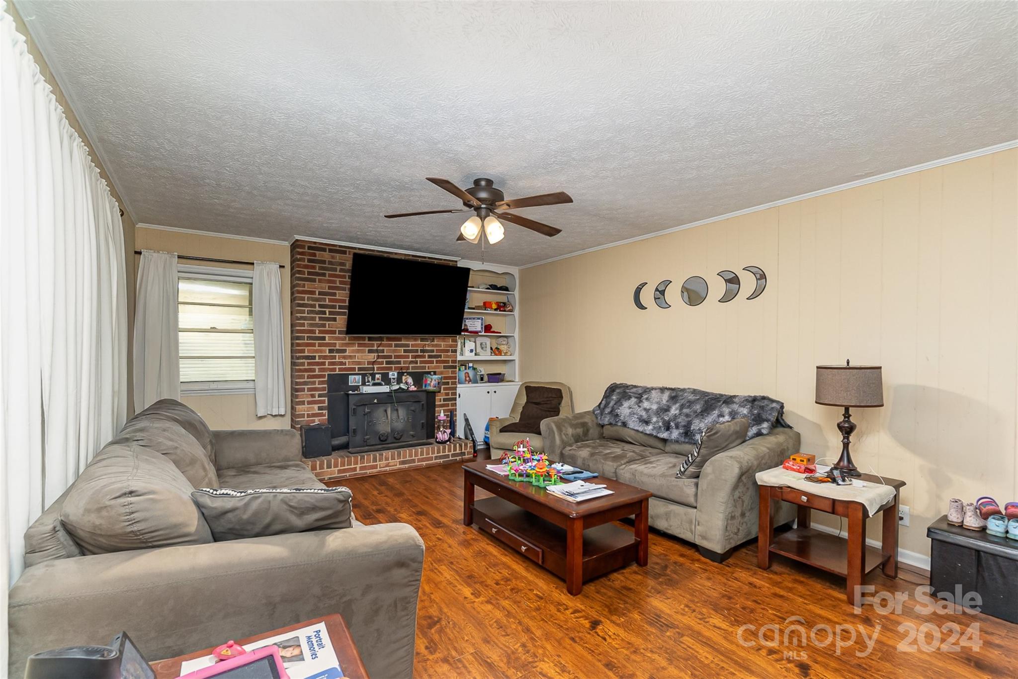 501 Weaver Street Cherryville, NC 28021 - Photo 7 of 26 a living room with furniture a flat screen tv and a window