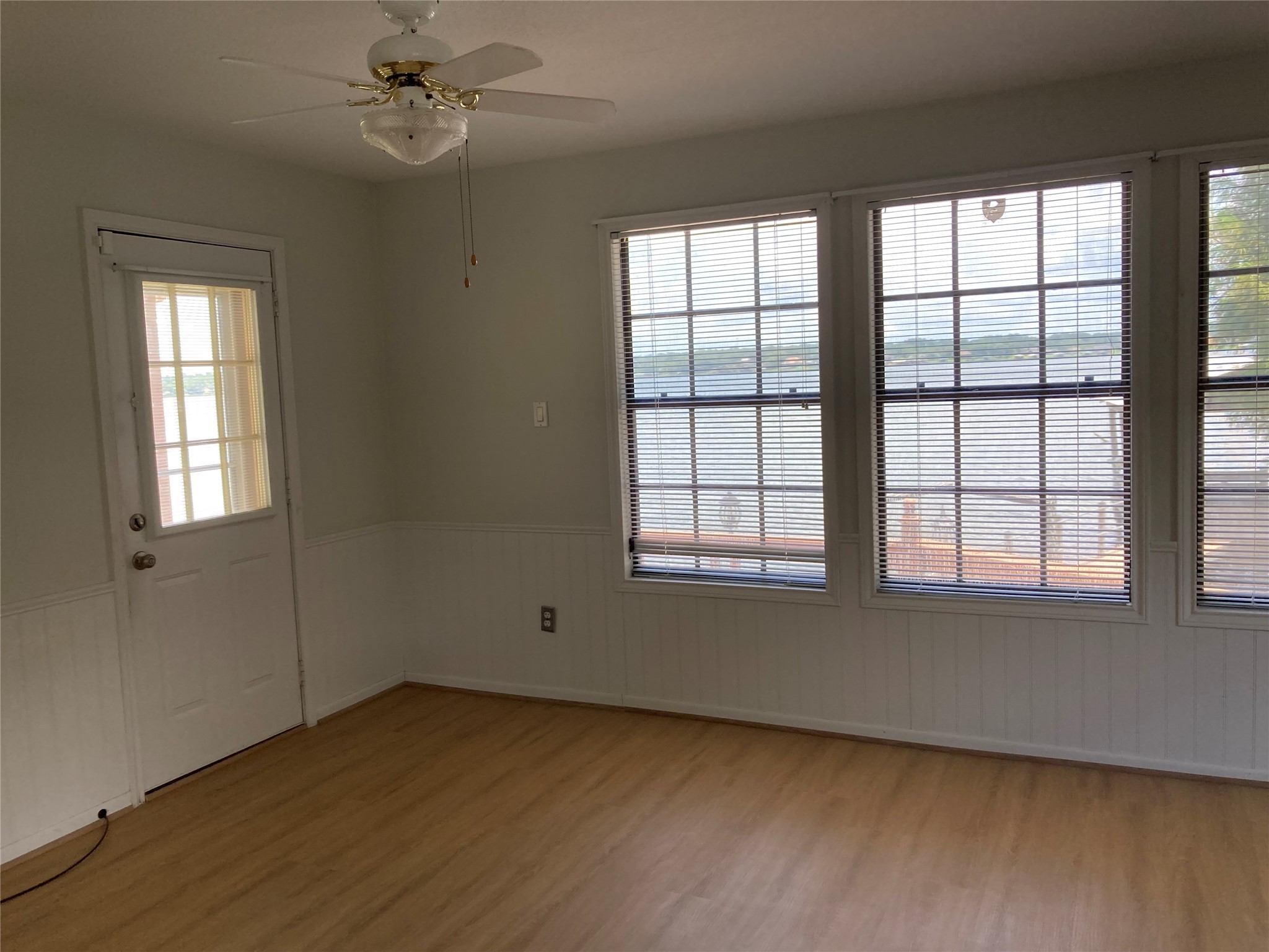 554 Harbor Drive Onalaska, TX 77360 - Photo 14 of 32 an empty room with wooden floor fan and windows