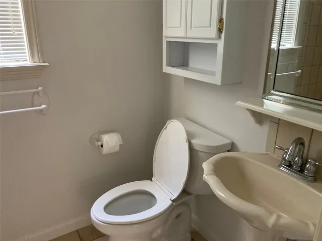 a view of a hallway with wooden floor and stairs