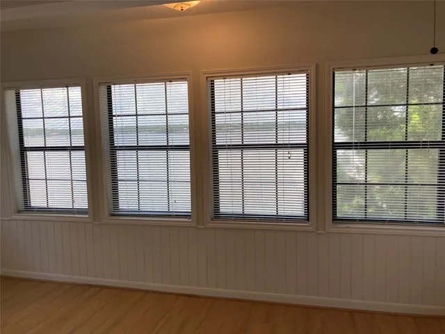 a view of a livingroom with wooden floor and stairs