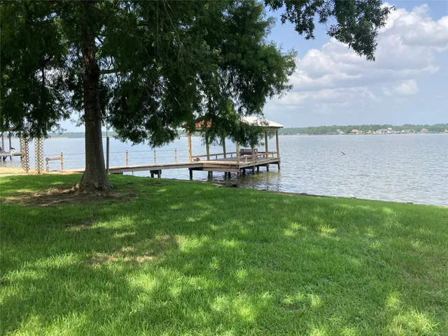 a view of a house with a yard and sitting area