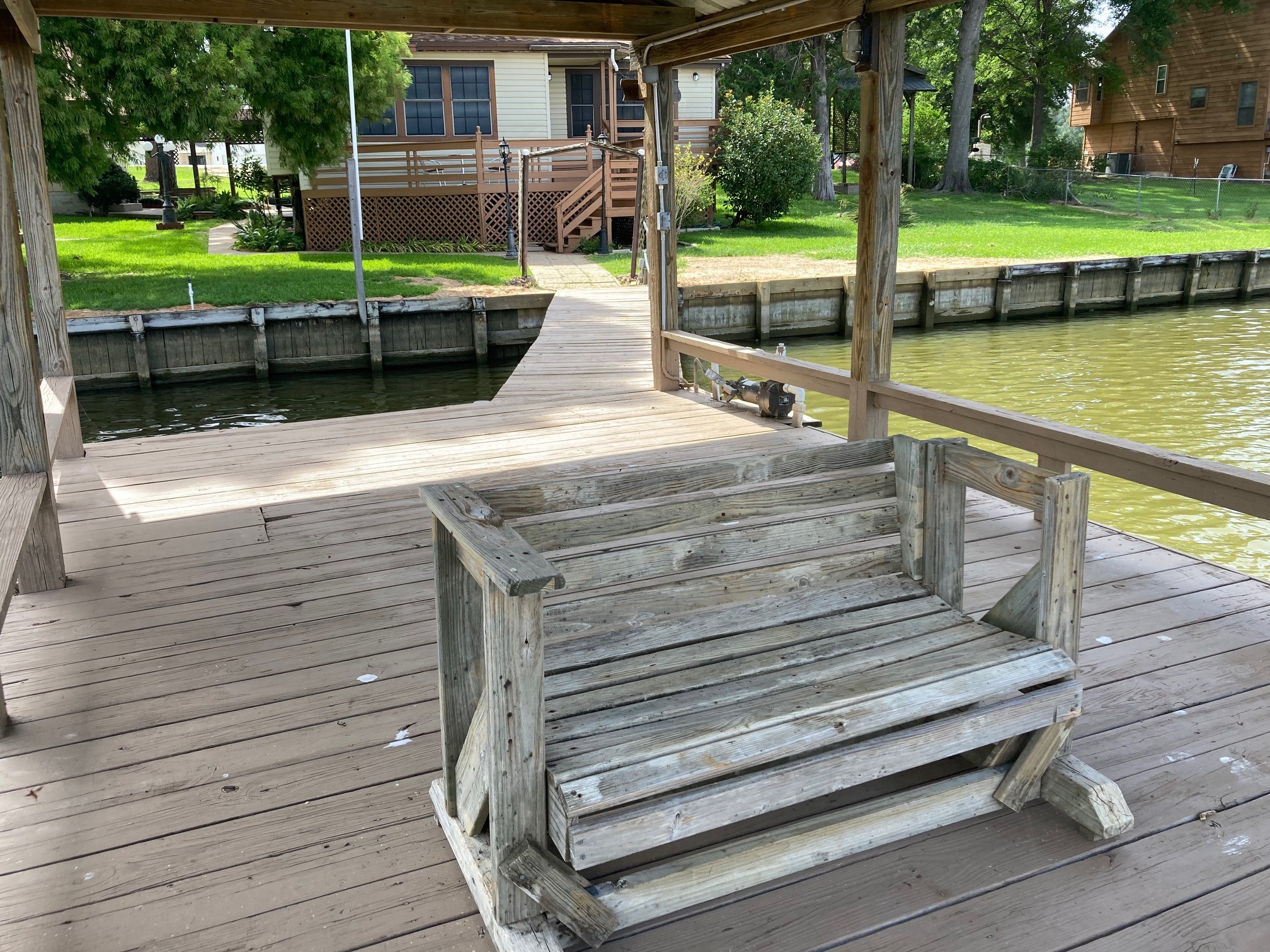 554 Harbor Drive Onalaska, TX 77360 - Photo 9 of 32 a view of a wooden deck with a bench