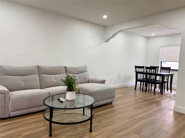 a living room with furniture and wooden floor