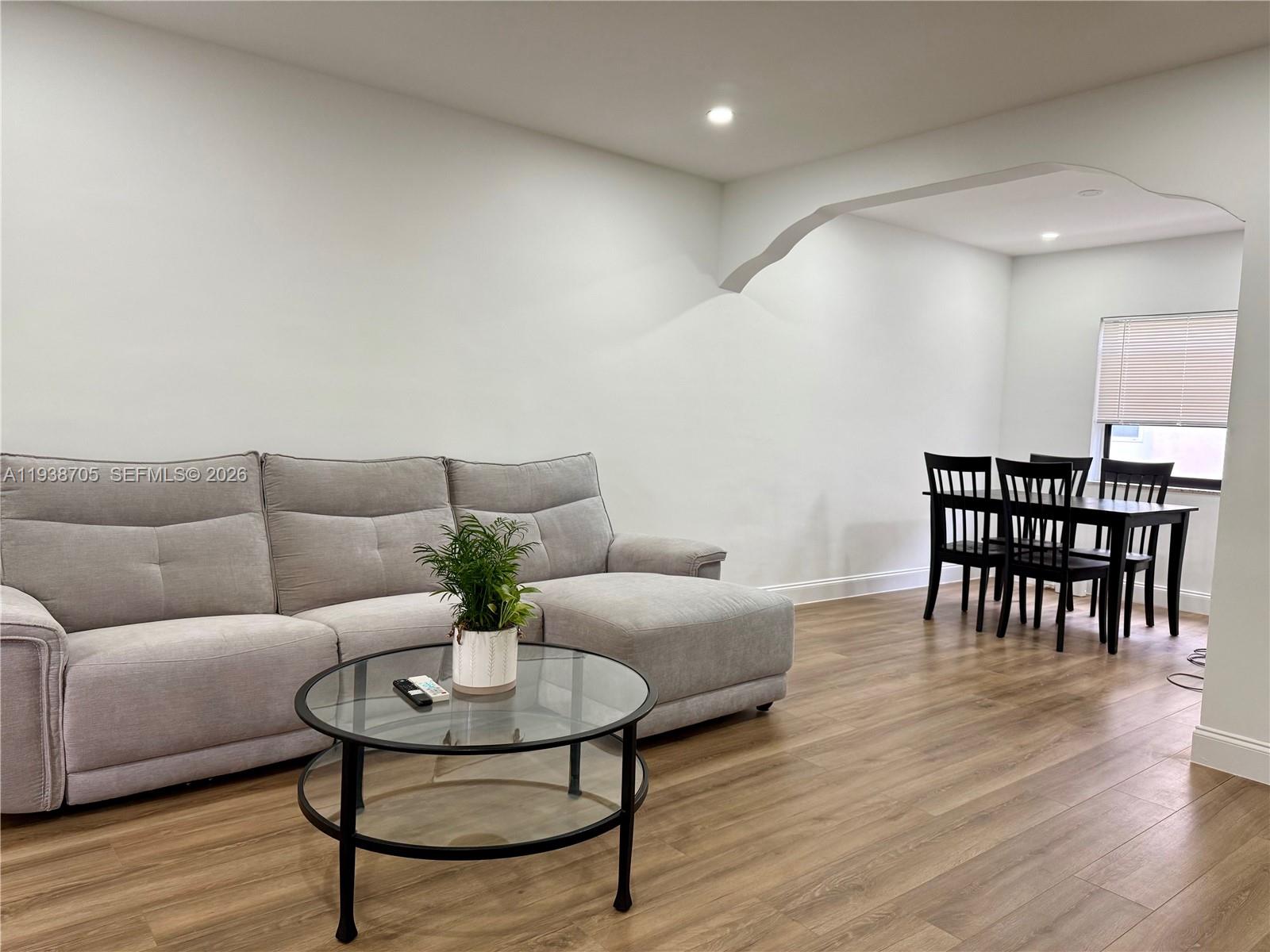 864 80th Street, Unit 1 Miami Beach, FL 33141 - Photo 3 of 13 a living room with furniture and wooden floor