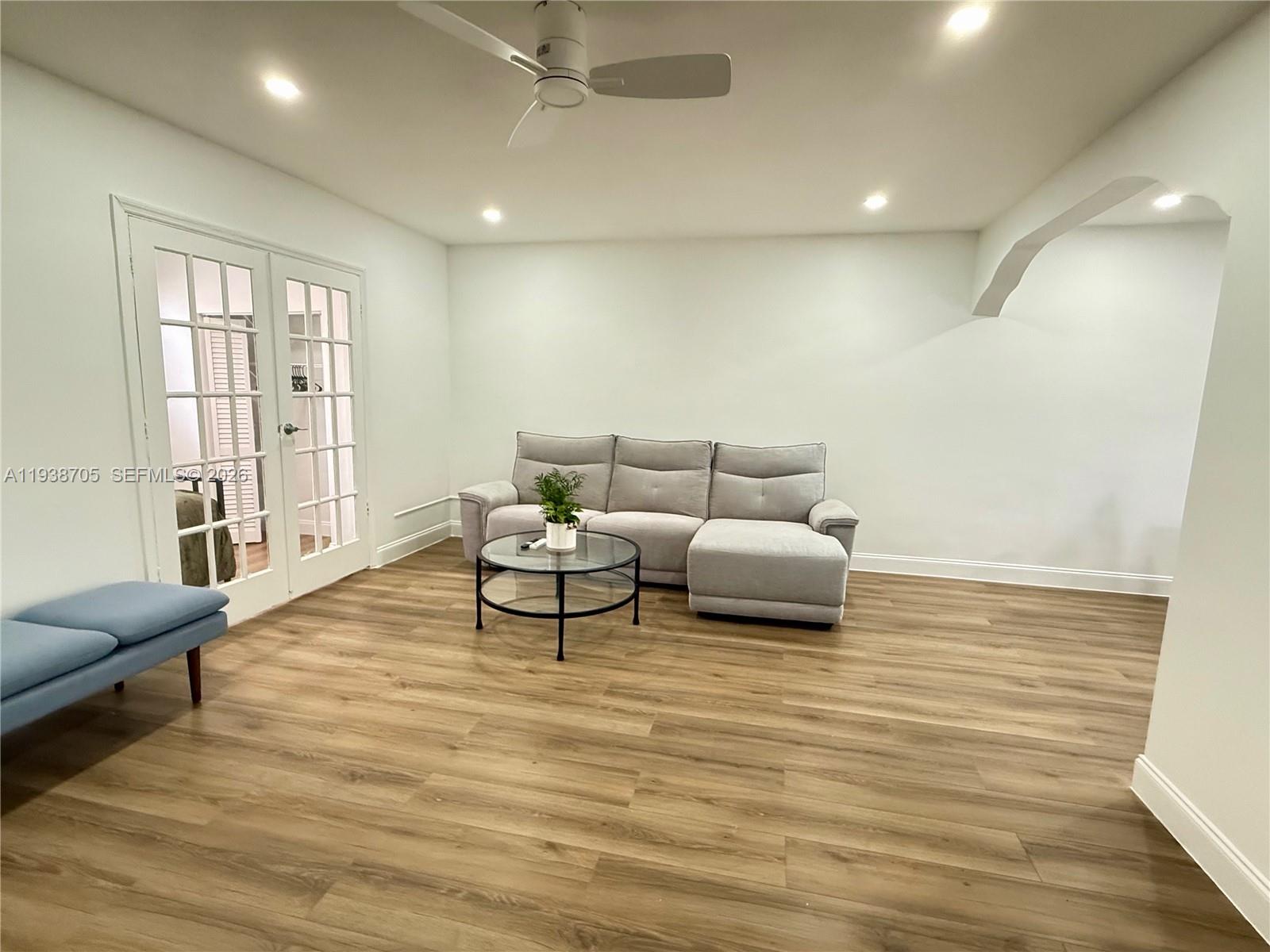 864 80th Street, Unit 1 Miami Beach, FL 33141 - Photo 4 of 13 a living room with furniture and a wooden floor