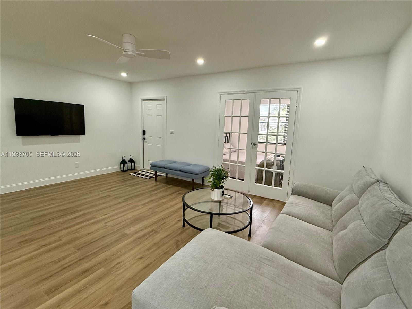 864 80th Street, Unit 1 Miami Beach, FL 33141 - Photo 5 of 13 a living room with furniture and a flat screen tv