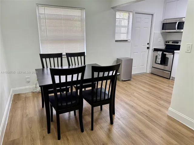 a view of a dining room with furniture and wooden floor