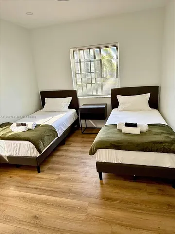 a bedroom with a bed lamp and a window