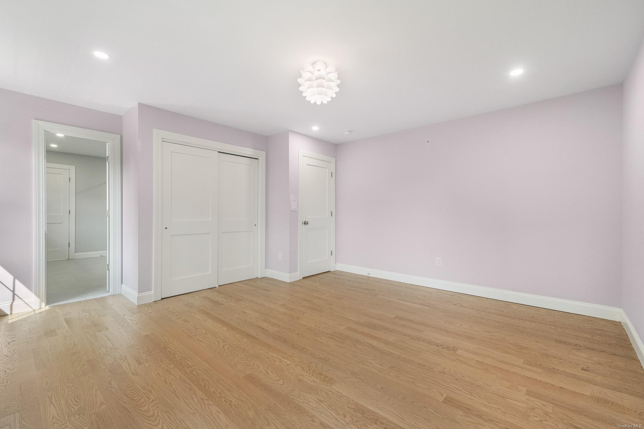 47 Laurel Lane Locust Valley, NY 11560 - Photo 29 of 39 Unfurnished bedroom featuring a closet and light hardwood / wood-style flooring