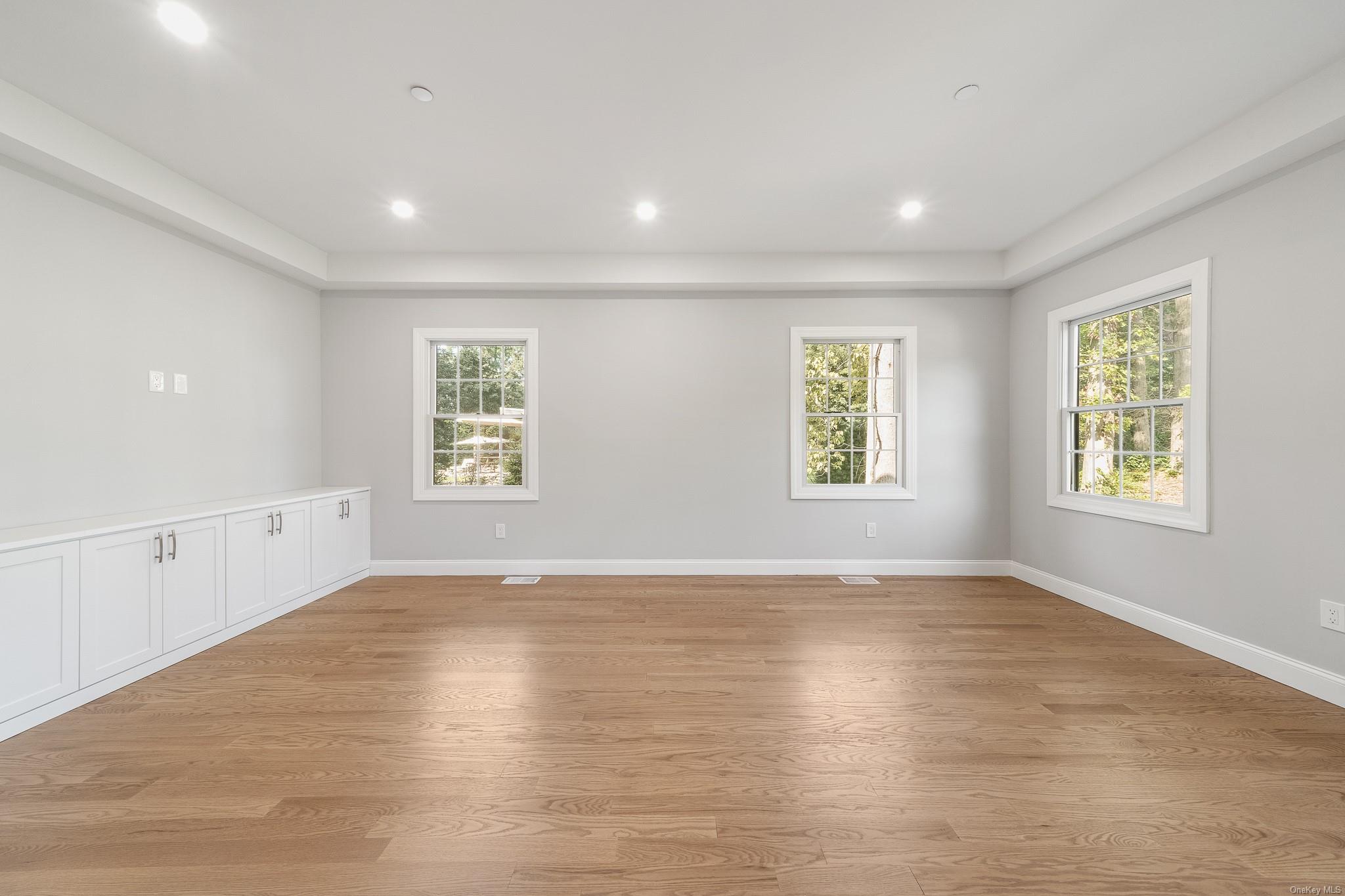 47 Laurel Lane Locust Valley, NY 11560 - Photo 5 of 39 Empty room with plenty of natural light and light wood-type flooring