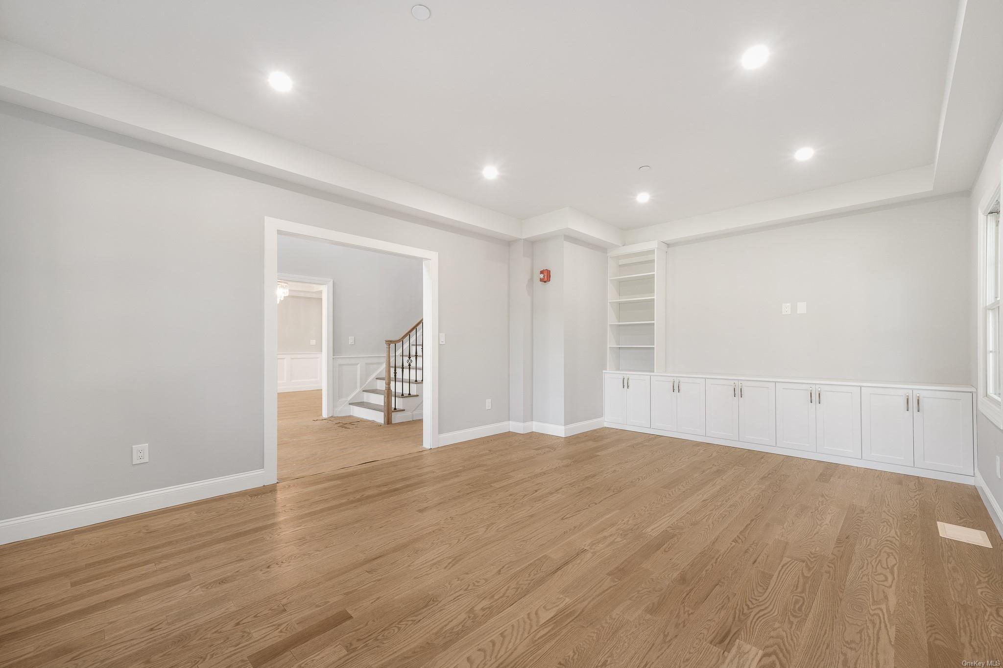 47 Laurel Lane Locust Valley, NY 11560 - Photo 6 of 39 Empty room featuring built in shelves and light hardwood / wood-style floors