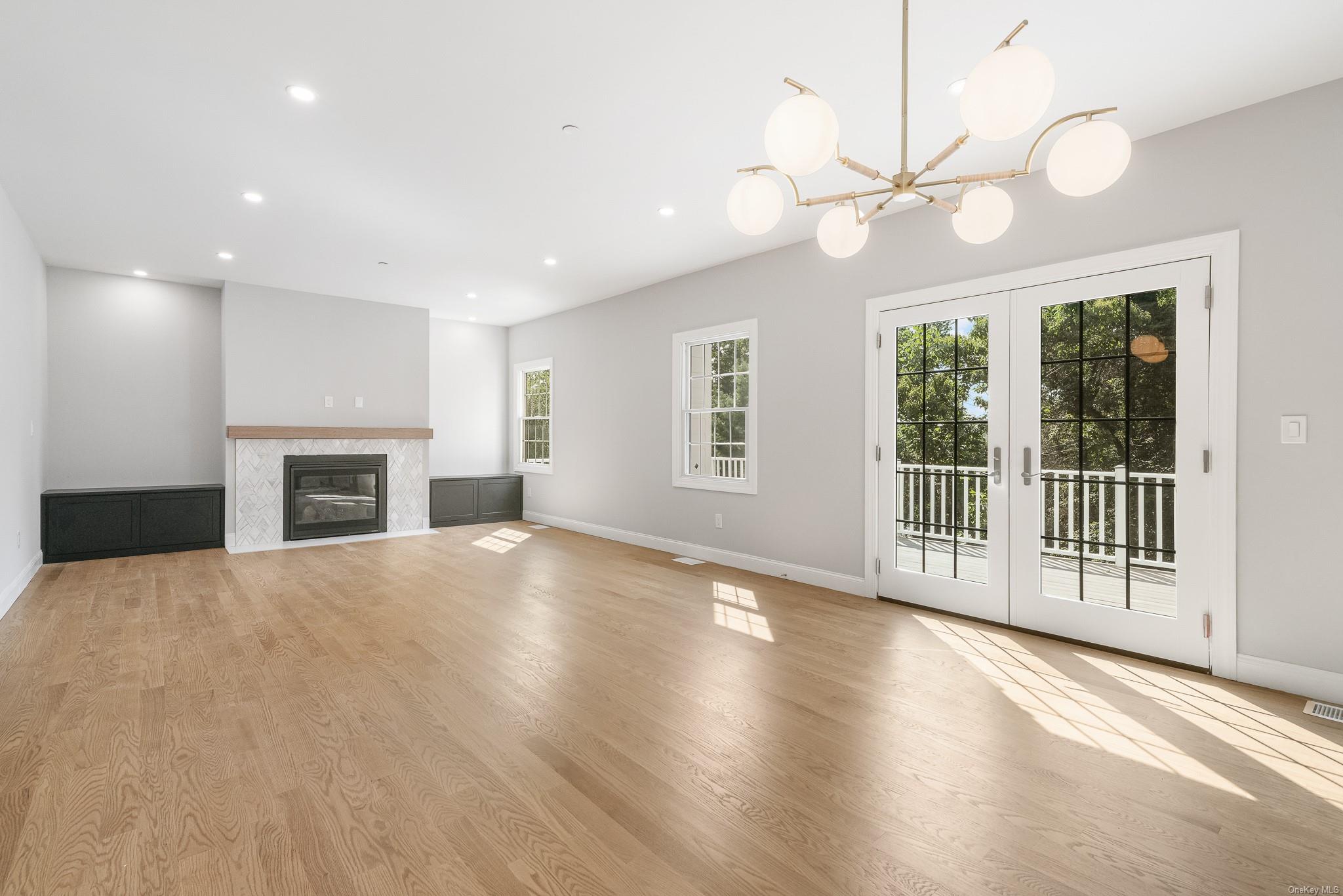 47 Laurel Lane Locust Valley, NY 11560 - Photo 9 of 39 Unfurnished living room with french doors and light hardwood / wood-style flooring
