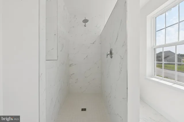 a bathroom with a glass shower door