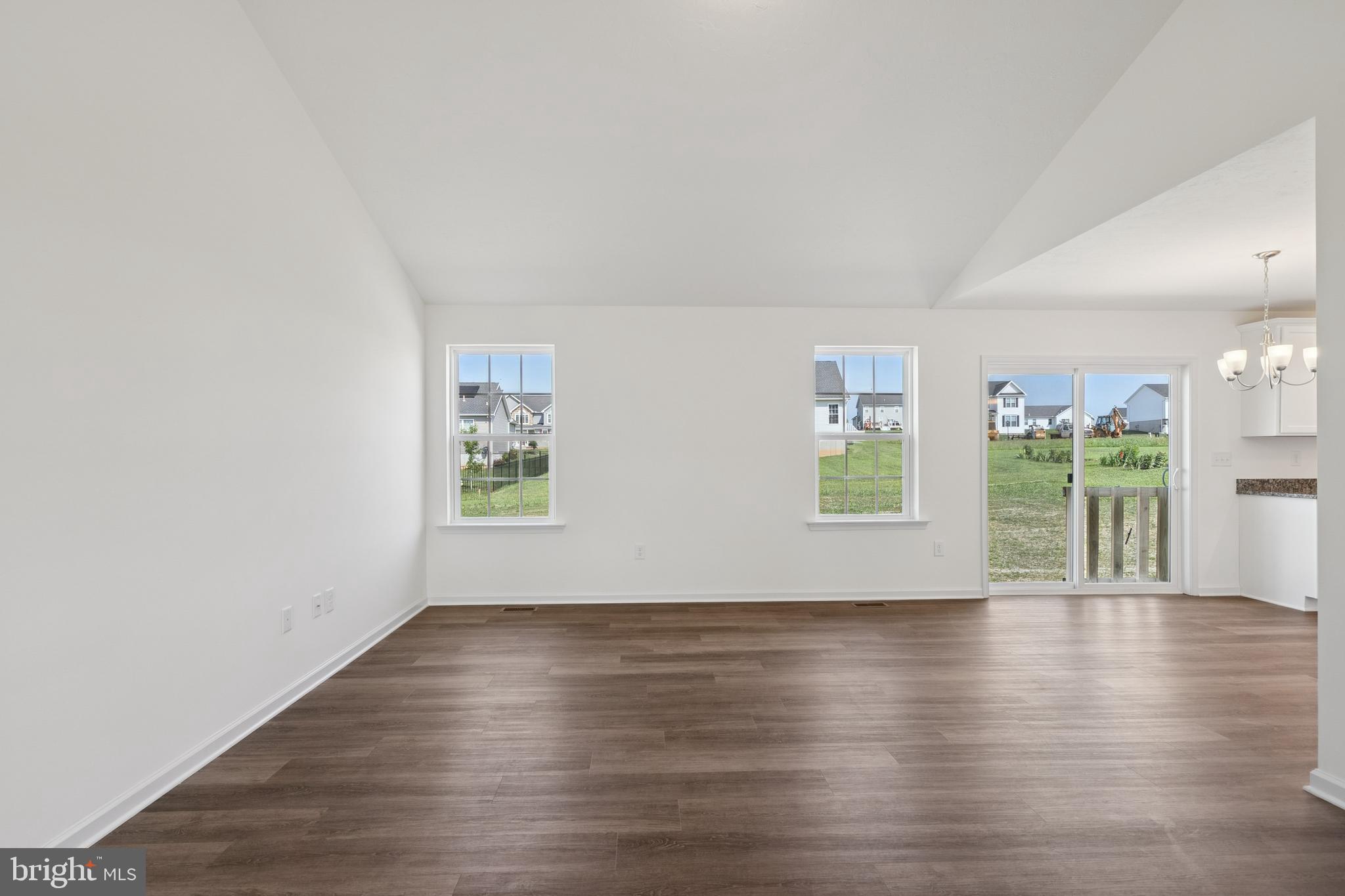 625 Ripple Drive, Unit 187 Hanover, PA 17331 - Photo 4 of 20 a view of an empty room with wooden floor and a window