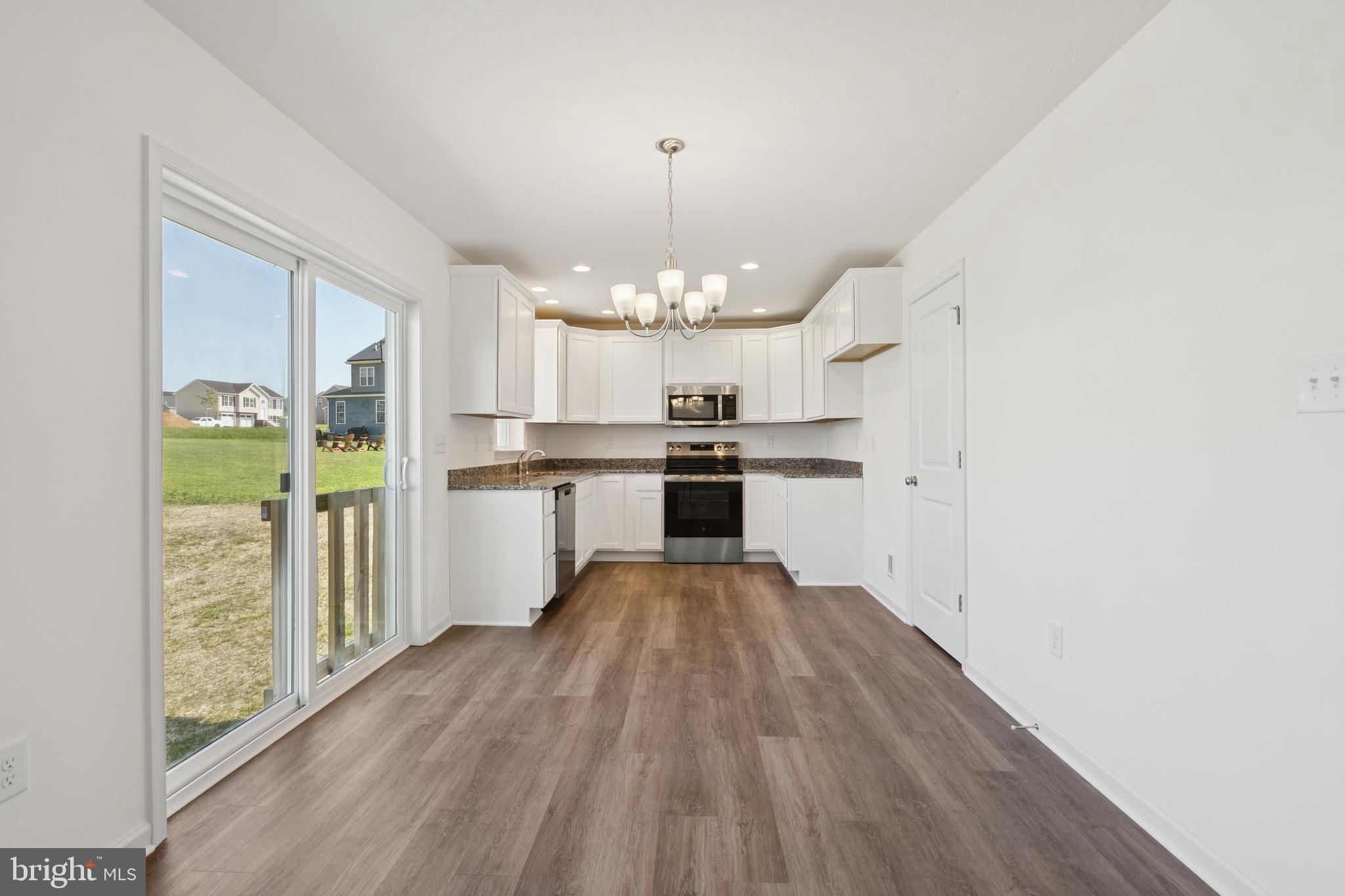 625 Ripple Drive, Unit 187 Hanover, PA 17331 - Photo 7 of 20 a view of a kitchen with wooden floor electronic appliances and window