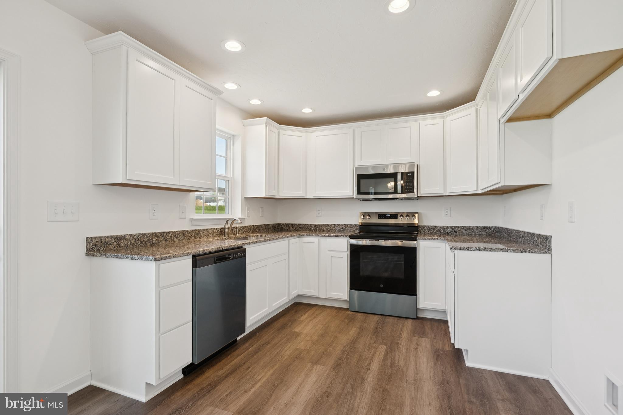 625 Ripple Drive, Unit 187 Hanover, PA 17331 - Photo 8 of 20 a kitchen with granite countertop white cabinets and black stainless steel appliances