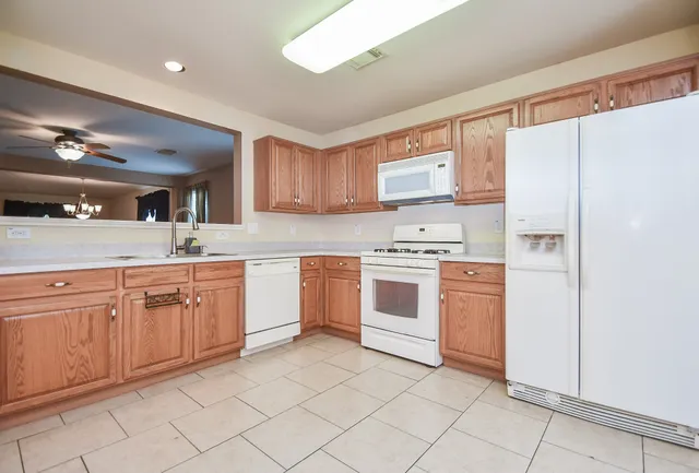 a kitchen with cabinets appliances and a window