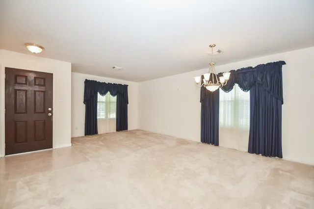 a view of a big room with closet and windows