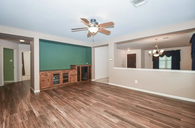 a view of a livingroom with a hardwood floor and a ceiling fan