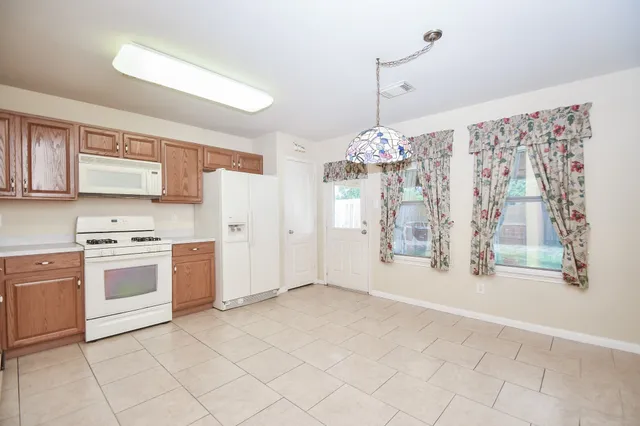 a view of a kitchen with electric appliances
