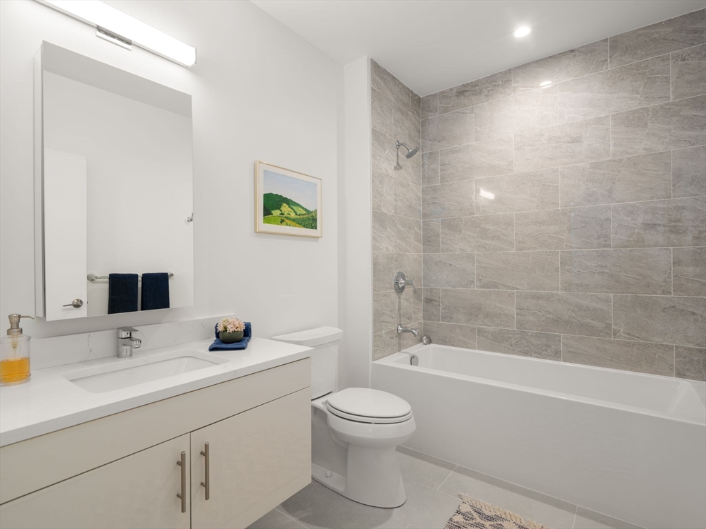 1151 Walnut Street, Unit 201 Newton, MA 02461 - Photo 13 of 31 a bathroom with a sink a toilet and shower