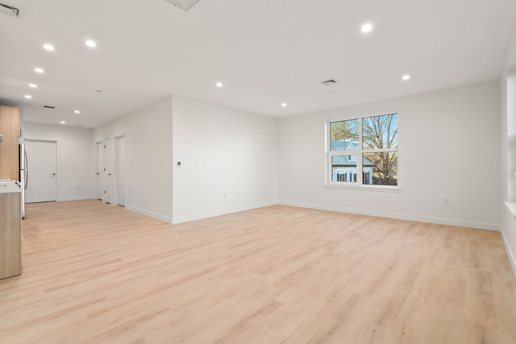 1151 Walnut Street, Unit 201 Newton, MA 02461 - Photo 18 of 31 an empty room with wooden floor and window