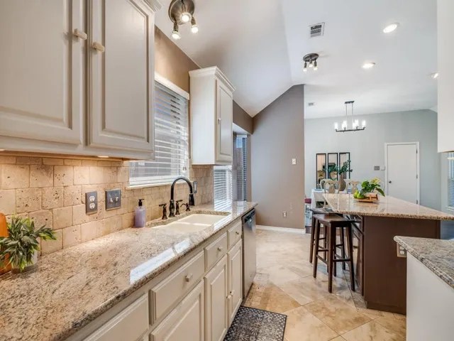 a kitchen with counter space sink stove and cabinets