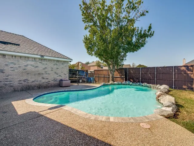 a view of a backyard with couches and a fire pit