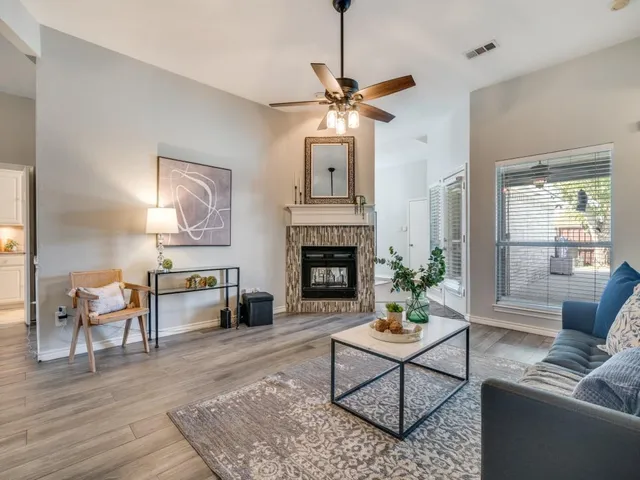 a living room with furniture a table and a fireplace